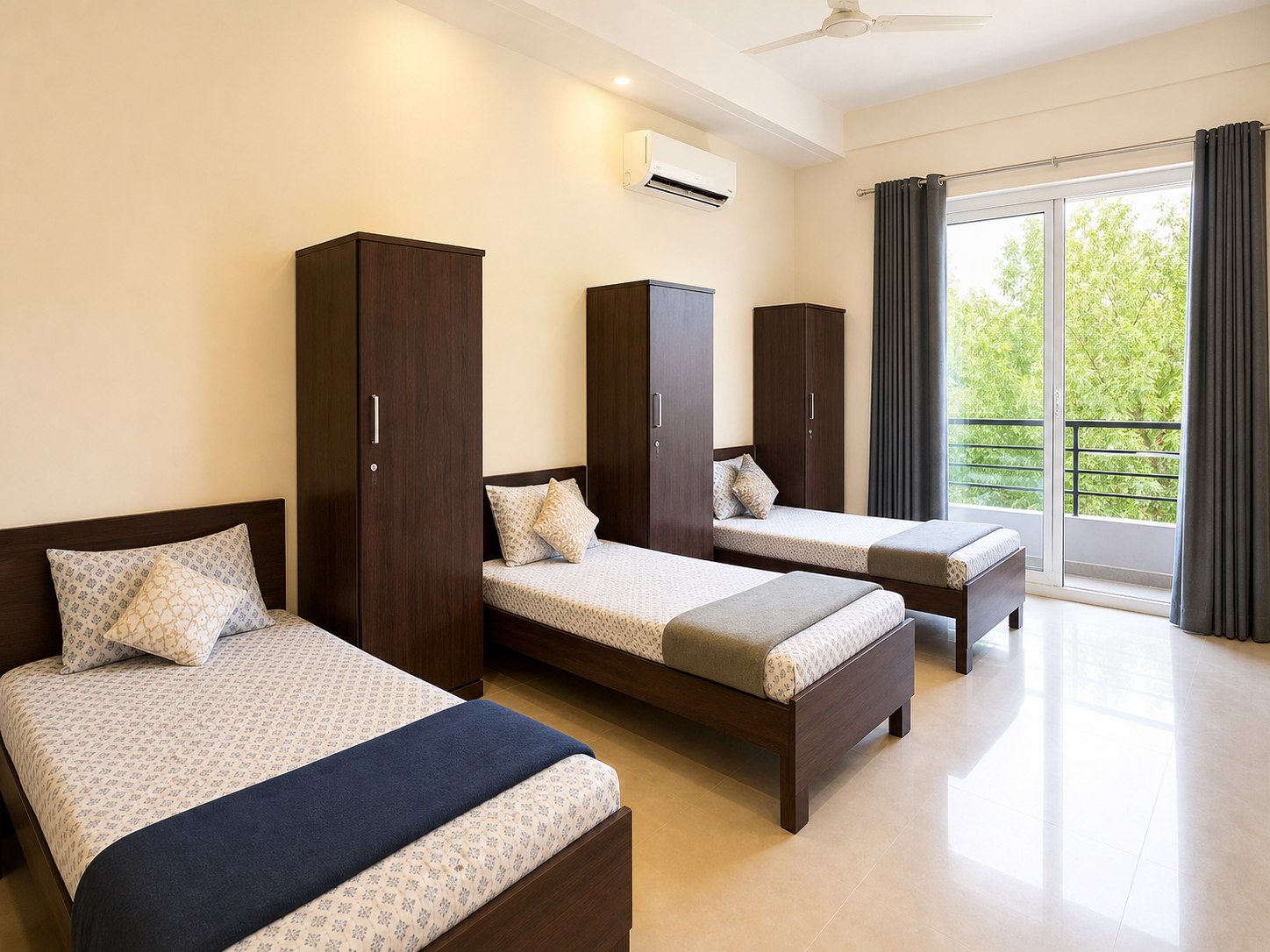 Triple seater AC room with beds, almirahs and balcony access